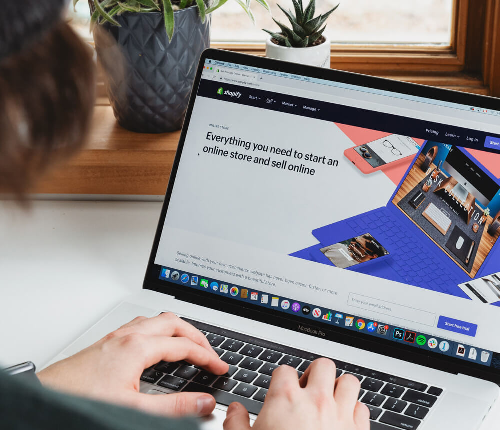 Person logging in to their Shopify website to check their checkout flow optimization