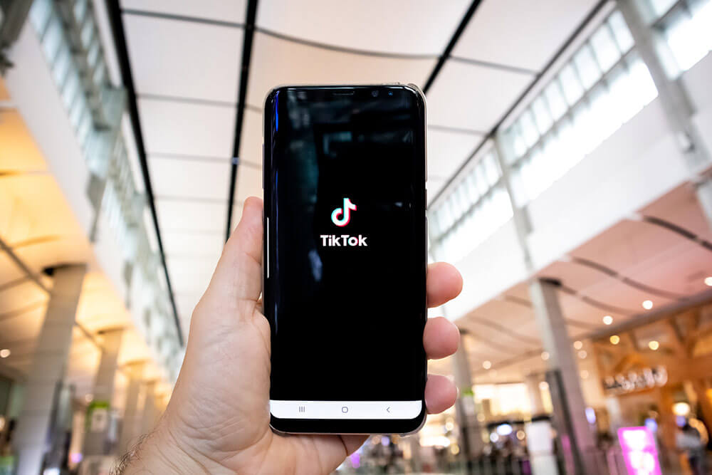 Photo of Hand Holding Phone - Man learning how to edit Tiktok videos