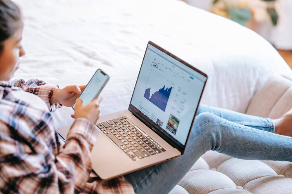 Want more website sales? This business owner is looking at their sales graph on their computer.