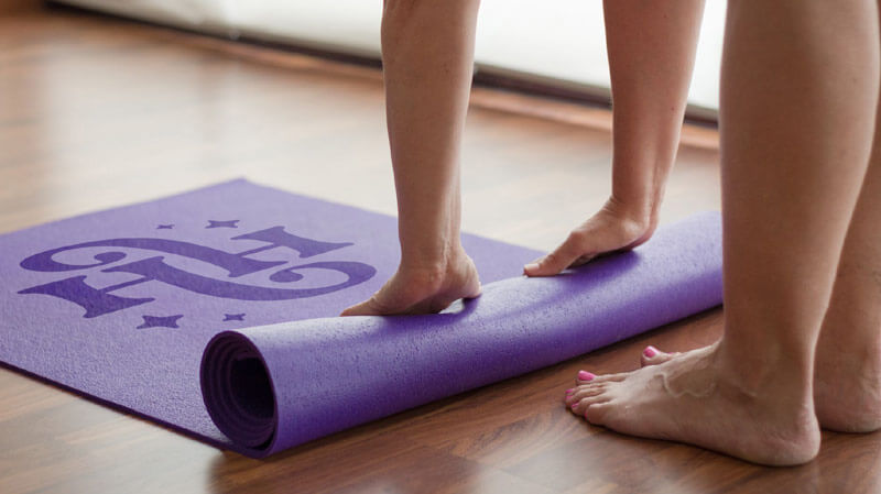All the best brand guides include logo design mockups - and here, we see the Hedonist Health logo design shown on a purple yoga mat.